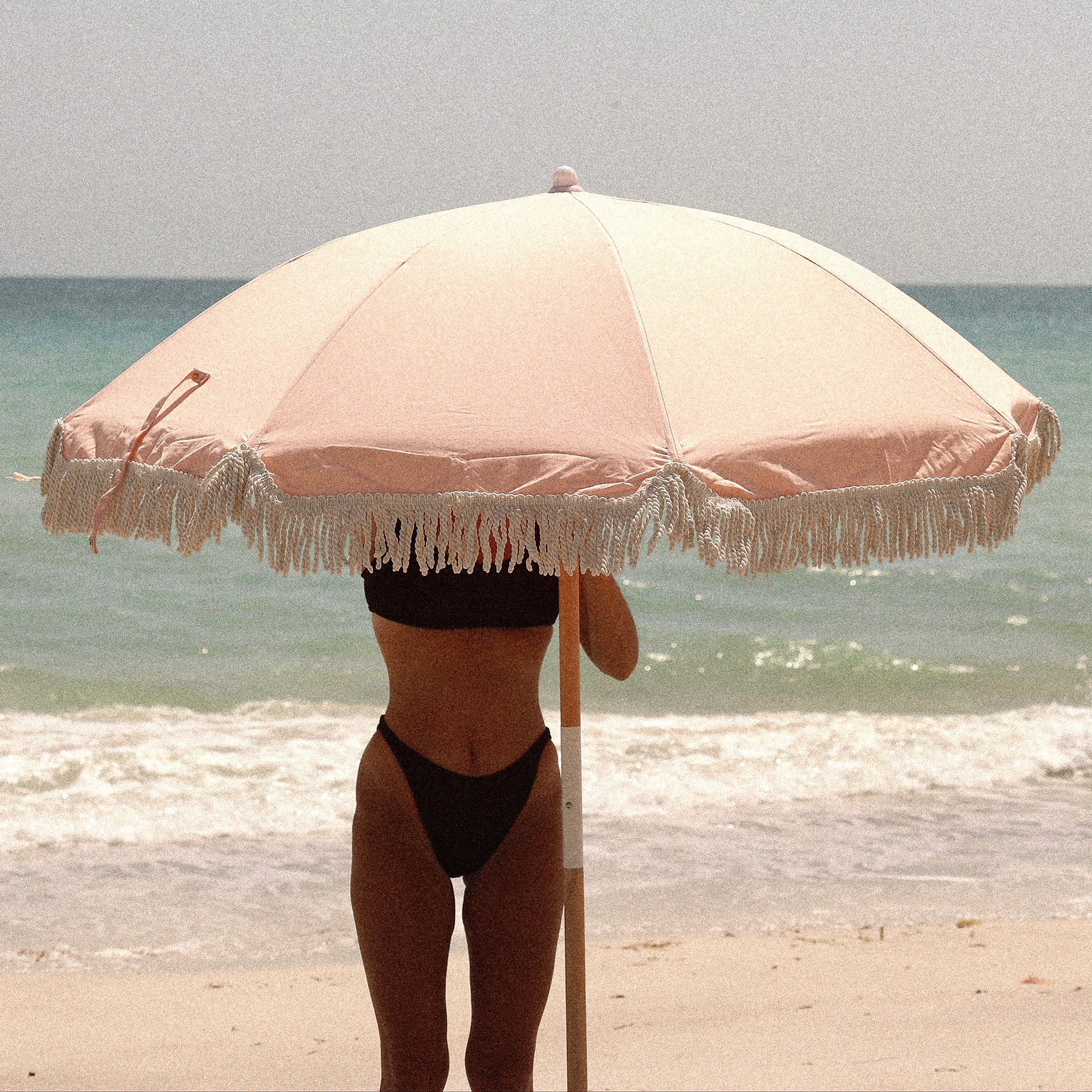 Pink beach umbrella with fringe
